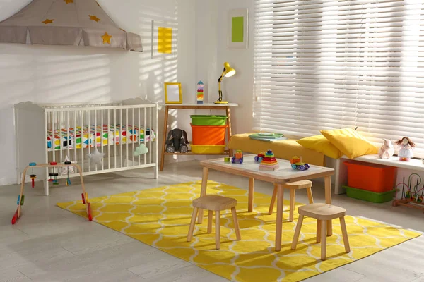 Cozy baby room interior with comfortable crib — Stock Photo, Image