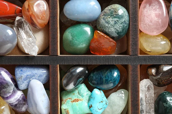 Box with different beautiful gemstones as background, top view — Stock Photo, Image