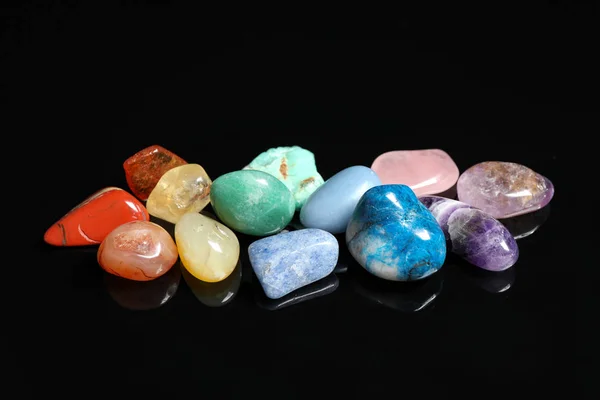 Pile of different beautiful gemstones on black background — Stock Photo, Image