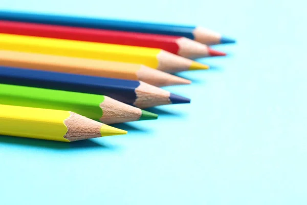 Colorful pencils on light blue background, closeup — Stock Photo, Image