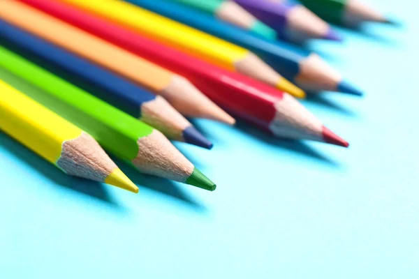 Colorful pencils on light blue background, closeup — Stock Photo, Image