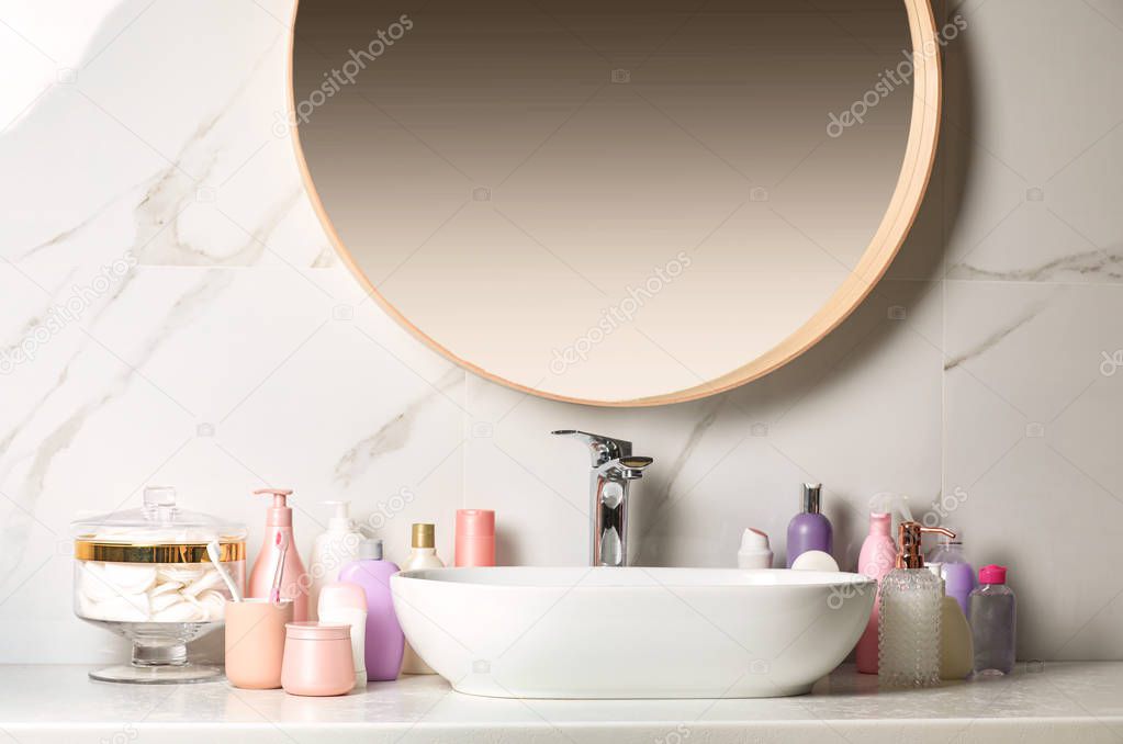 Stick deodorant and different toiletry on countertop in bathroom