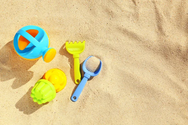 Kum üzerinde plastik plaj oyuncakları ile Düz yatıyordu kompozisyon. Metin için alan — Stok fotoğraf