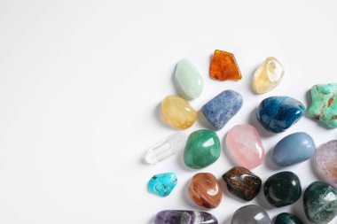Different beautiful gemstones on white background, top view clipart