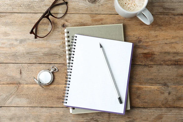 Flat lay composition with office stationery and cup of coffee on wooden table — Stock Photo, Image