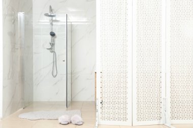 Modern bathroom interior with shower stall and folding screen clipart