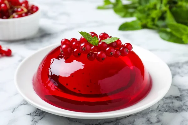 Ízletes friss vörös zselék, bogyós gyümölcsök és menta a márvány asztalon — Stock Fotó