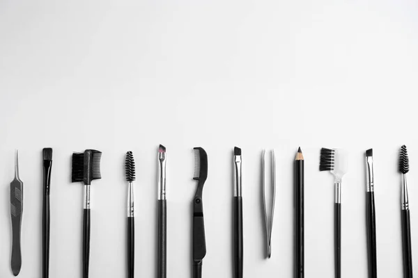 Set of professional eyebrow tools on white background, flat lay. Space for text — Stock Photo, Image