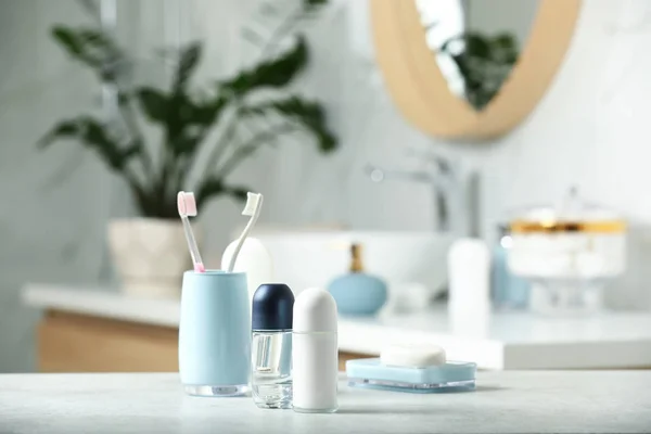 Roll-on deodorants with toiletry on table in bathroom, space for text — Stock Photo, Image