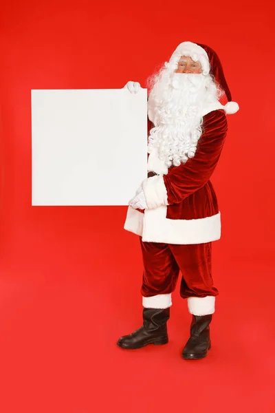 Authentischer Weihnachtsmann mit leerem Banner auf rotem Hintergrund. Raum für Gestaltung — Stockfoto