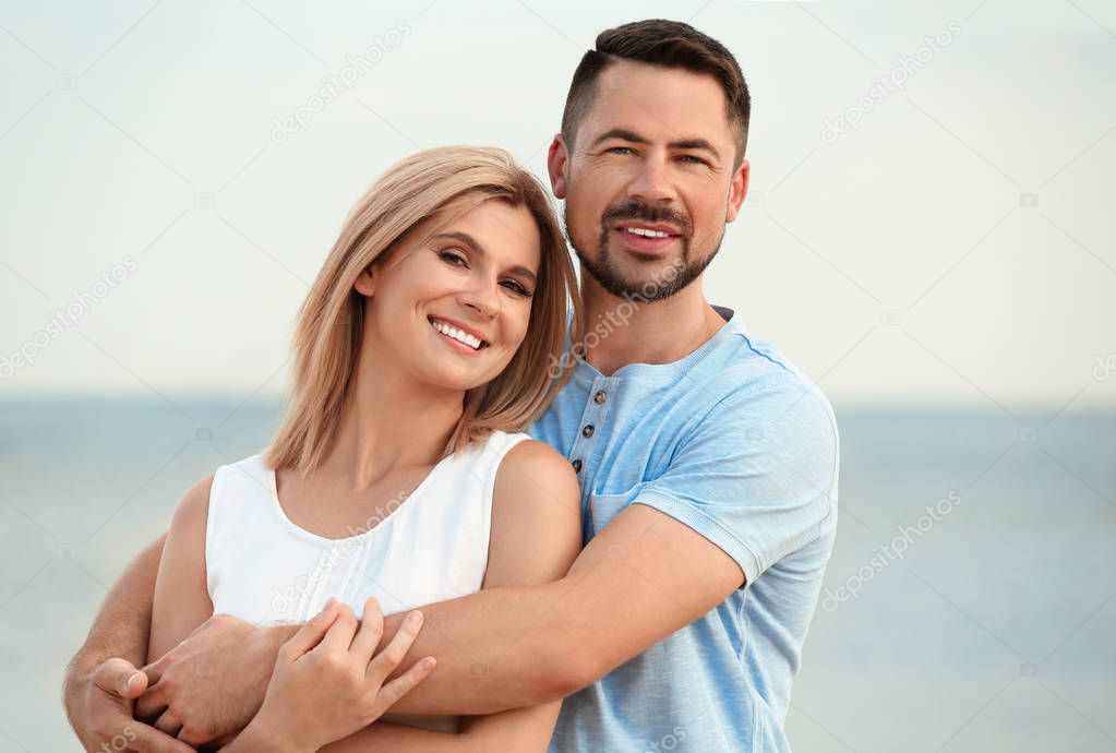 Happy romantic couple spending time together on beach
