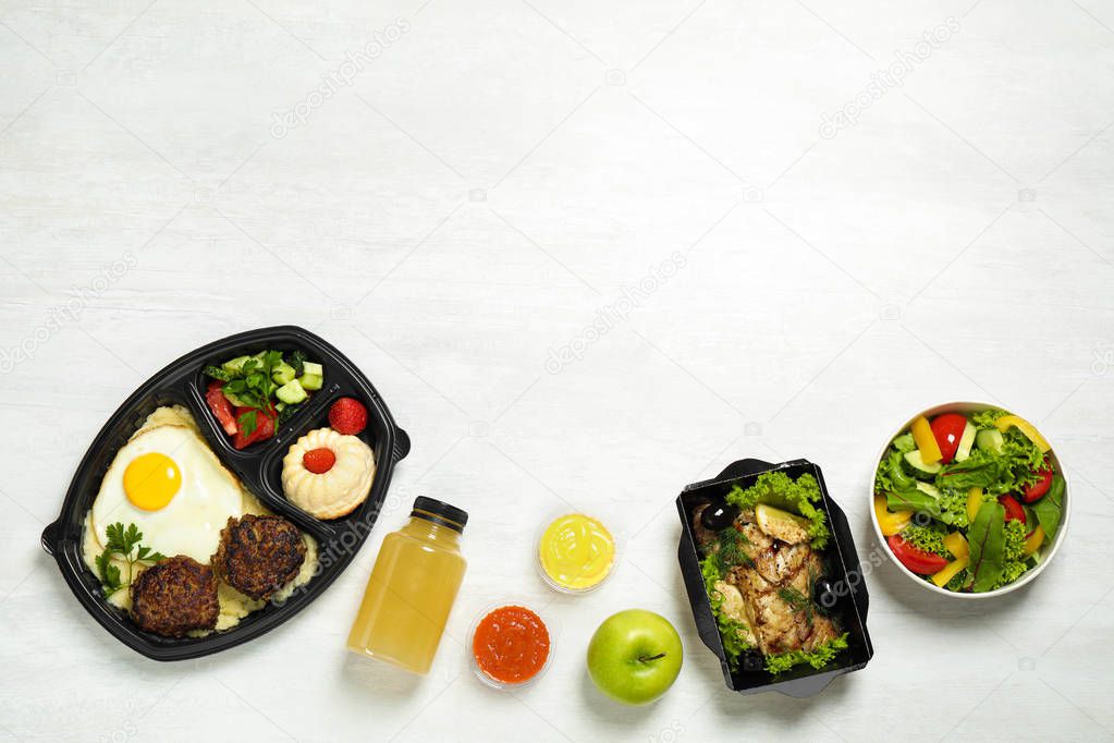 Flat lay composition with lunchboxes on white table, space for text. Healthy food delivery