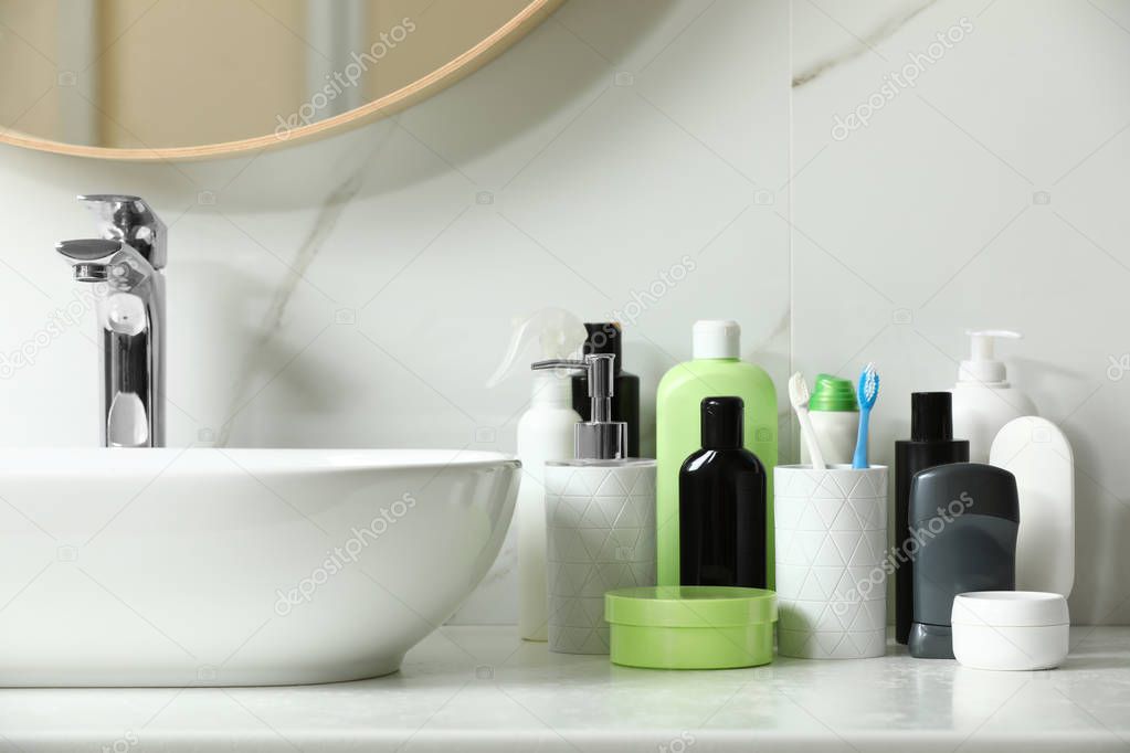 Stick deodorant and different toiletry on countertop in bathroom