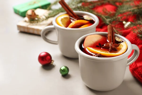 Cups of tasty mulled wine on grey table. Space for text — Stock Photo, Image
