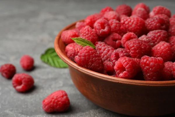 Bowl with delicious ripe raspberries on stone surface, closeup. Space for text — Stock Photo, Image