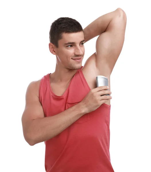 Hombre joven aplicando desodorante a la axila sobre fondo blanco — Foto de Stock