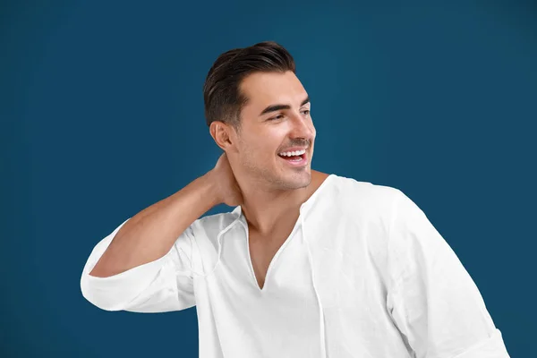 Portrait of handsome young man on blue background — Stock Photo, Image