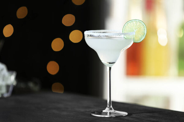 Fresh alcoholic cocktail with lemon and sugar on bar counter