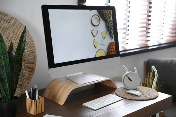 Comfortabele werkplek nabij raam met horizontale jaloezieën in de kamer — Stockfoto