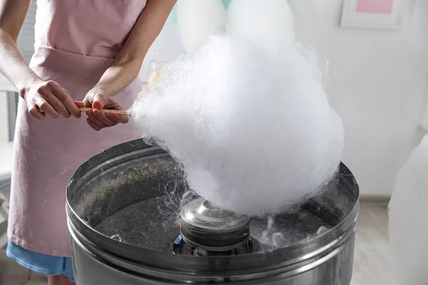 Mulher fazendo algodão doce usando máquina moderna dentro de casa, close-up — Fotografia de Stock