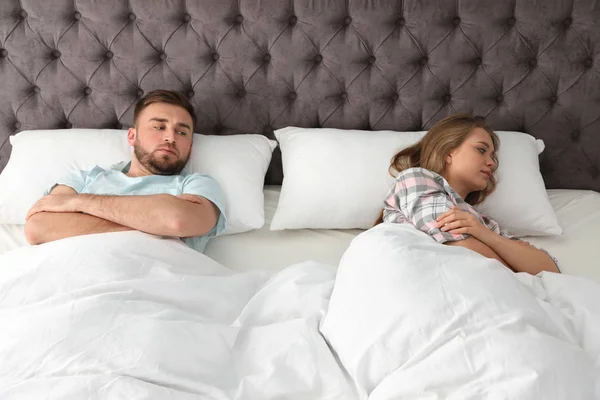 Casal jovem com problemas de relacionamento na cama em casa — Fotografia de Stock