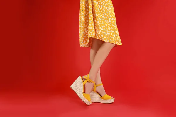 Woman in stylish shoes on red background — Stock Photo, Image