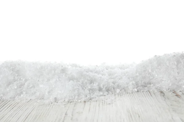 Hromada sněhu na dřevěném povrchu na bílém pozadí. Vánoční sezóna — Stock fotografie