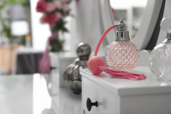 Bottles of perfumes on white dressing table — Φωτογραφία Αρχείου