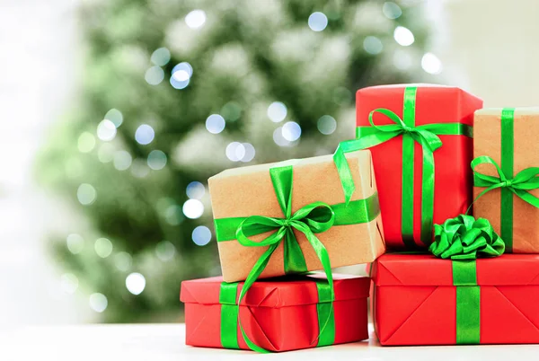 Christmas gifts on table against blurred background. Space for text — Stock Photo, Image