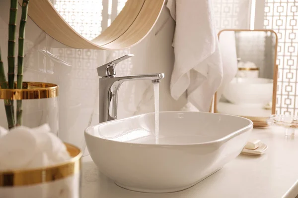 Sink with running water in stylish bathroom interior — Stock Photo, Image