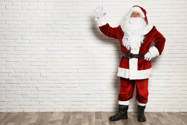 Auténtico Santa Claus contra la pared de ladrillo blanco. Espacio para texto —  Fotos de Stock