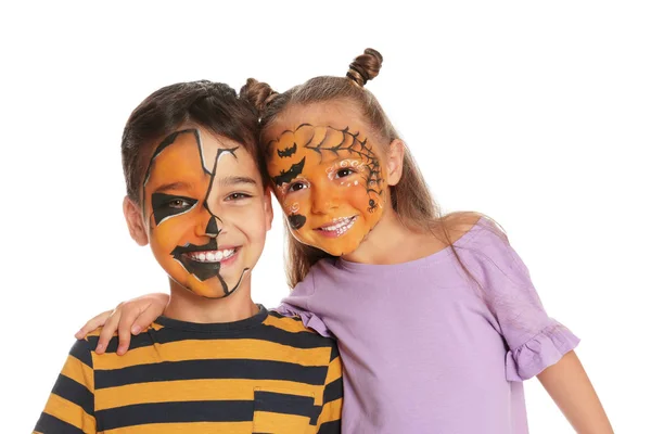 Lindos niños pequeños con pintura facial sobre fondo blanco — Foto de Stock