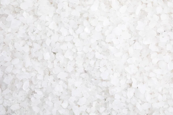 White sea salt as background, top view. Spa treatment — Stock Photo, Image