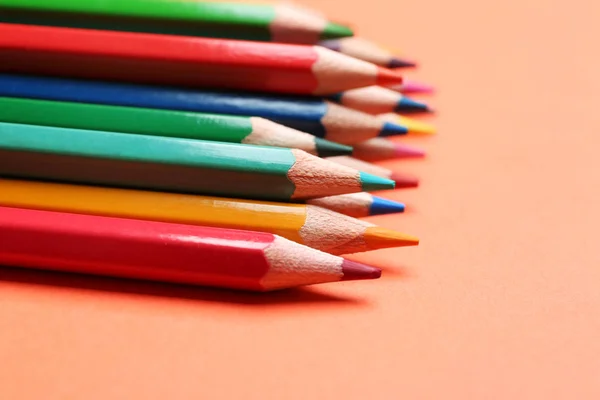 Different color pencils on coral background, closeup — Stock Photo, Image