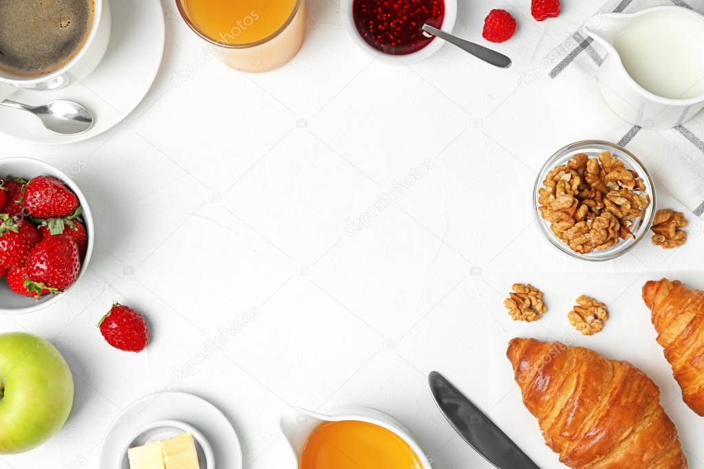 Frame made with tasty meal for breakfast on white table, flat lay. Space for text