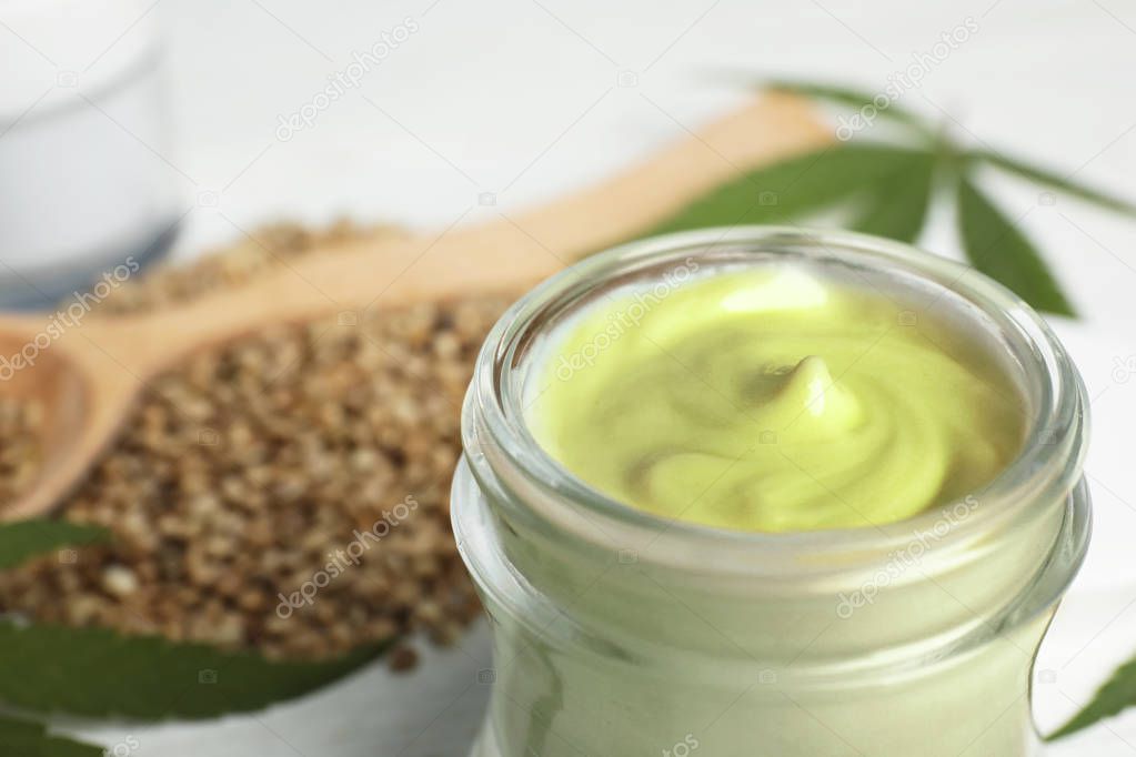 Jar of hemp cream on table, closeup. Organic cosmetics