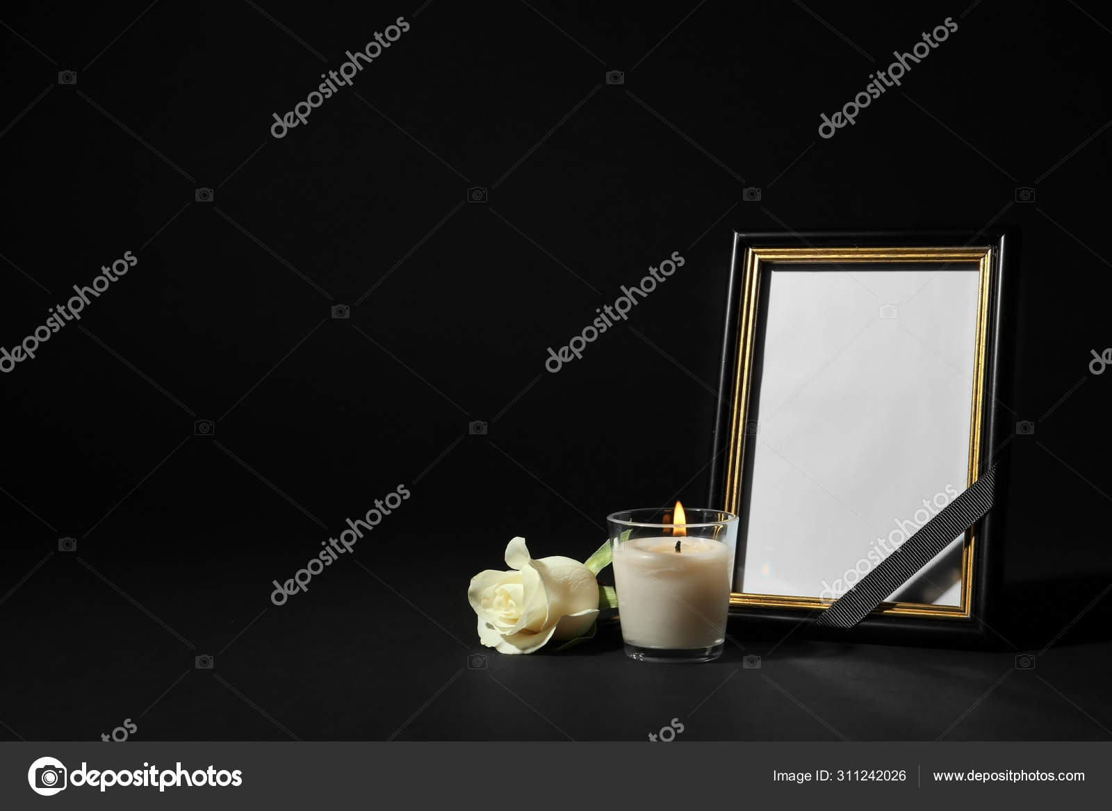 Funeral photo frame with ribbon, white rose and candle on black background.  Space for design Stock Photo by ©NewAfrica 311242026
