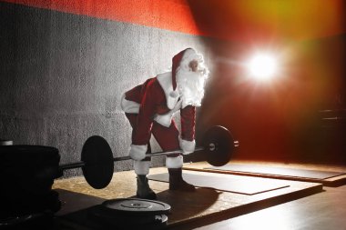 Genç Noel Baba modern spor salonunda eğitim görüyor.