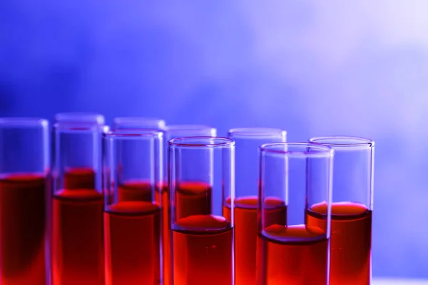 Closeup view of many test tubes with red liquid, color tone effect — ストック写真