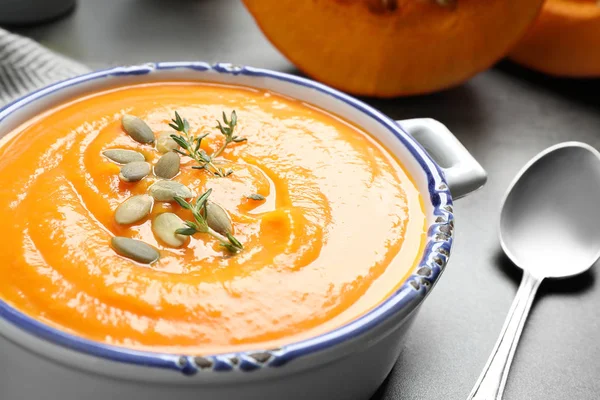 Delicious pumpkin soup in bowl on grey table, closeup — Stock Photo, Image