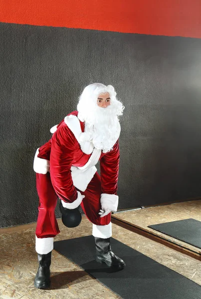 Young Santa Claus training in modern gym — Stock Photo, Image
