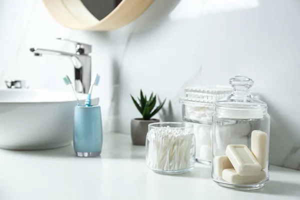 Pamut törlőkendők és szappantartók fehér pulton a fürdőszobában — Stock Fotó