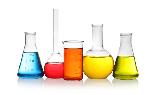 Laboratory glassware with colorful liquids on white background — Stock Photo, Image