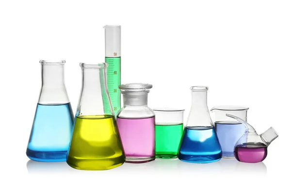 Laboratory glassware with colorful liquids on white background — Stock Photo, Image