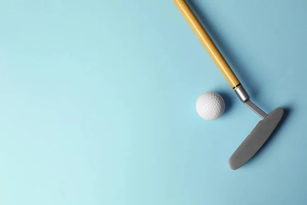 Golf piłka i klub na jasnoniebieskim tle, płaski leżał. Miejsce na tekst — Zdjęcie stockowe