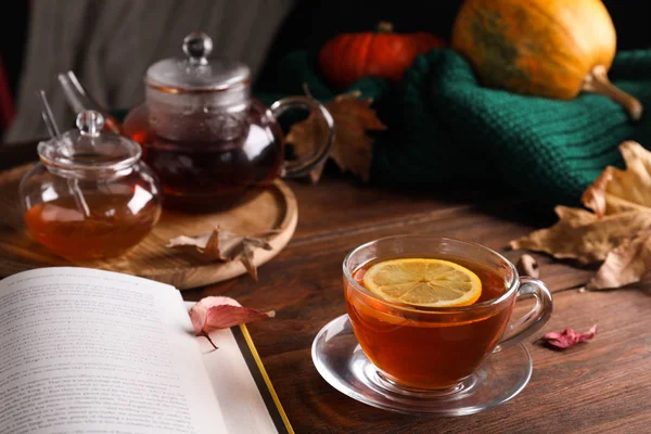 Cup of hot drink and book on wooden table. Cozy autumn atmosphere — Stock Photo, Image