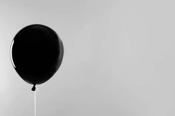 Black balloon for Halloween party on light grey background, space for text — Stock Photo, Image