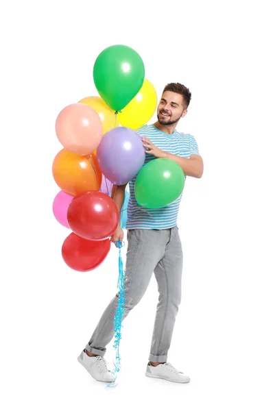 Ung man som håller gäng färgglada ballonger på vit bakgrund — Stockfoto