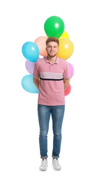 Joven sosteniendo racimo de globos de colores sobre fondo blanco — Foto de Stock