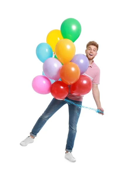 Känslomässig ung man håller gäng färgglada ballonger på vit bakgrund — Stockfoto